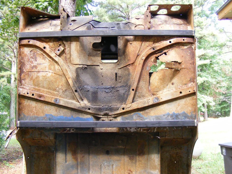 rusted vehicle chassis, looks like front end is missing