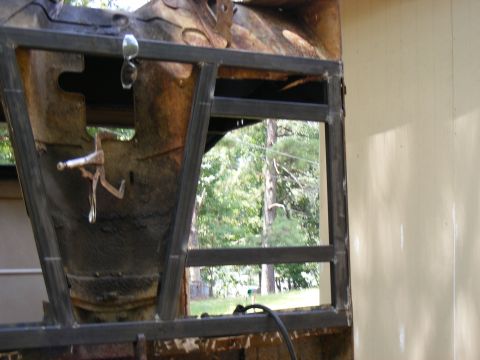 rusted vehicle body section with new metal bracing welded in place