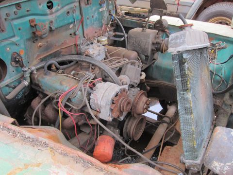 2001 Ford Crown Victoria - The engine bay of an older vehicle shows a V8 engine with various components and wiring.
