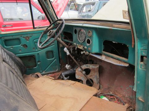 2001 Ford Crown Victoria - The interior of a vehicle shows significant wear and tear, with missing parts and exposed components.