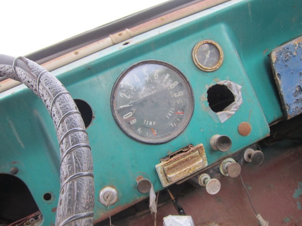 Interior dashboard with round gauge cluster showing fuel, oil, amp, and temperature
