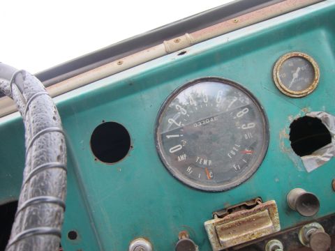 2001 Ford Crown Victoria - Interior view of a vintage vehicle's dashboard, multiple gauges and a worn steering wheel.