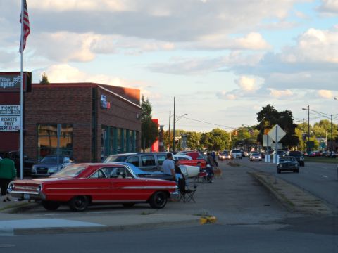 1971 Ford Ranchero - A classic red Ford Falcon is parked on the side of the road during a gathering.