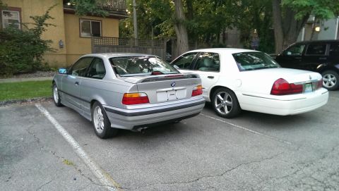 1997 BMW 3 Series - Silver BMW 3 Series coupe parked next to a white sedan.