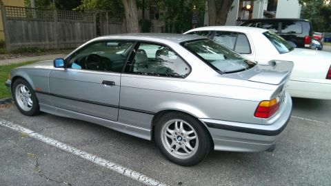 1997 BMW 3 Series - This silver 1997 BMW 3 Series coupe is parked in a lot next to a white sedan.