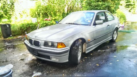 1997 BMW 3 Series - Silver 1997 BMW 3 Series coupe parked outside on a wet driveway.