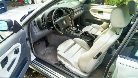 1997 BMW 3 Series - The interior of a 1997 BMW 3 Series convertible is shown, light-colored leather seats and dashboard details.