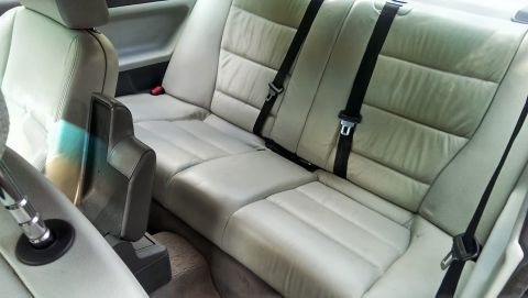 1997 BMW 3 Series - Interior view of the rear seats and center console of a car.