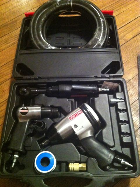1992 Ford Bronco - A collection of pneumatic tools, including an impact wrench and air ratchet, are neatly organized in a black carrying case.