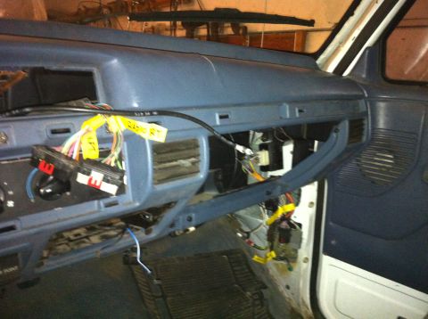 1992 Ford Bronco - The dashboard of a vehicle is shown with exposed wiring and electrical components.
