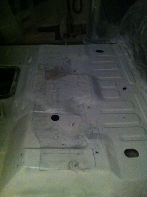 1992 Ford Bronco - The bare metal floor of a vehicle interior is visible, showing its ribbed construction.
