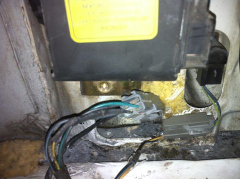1992 Ford Bronco - Close-up view of a wiring harness and an electrical component, likely from a vehicle's interior or engine bay.