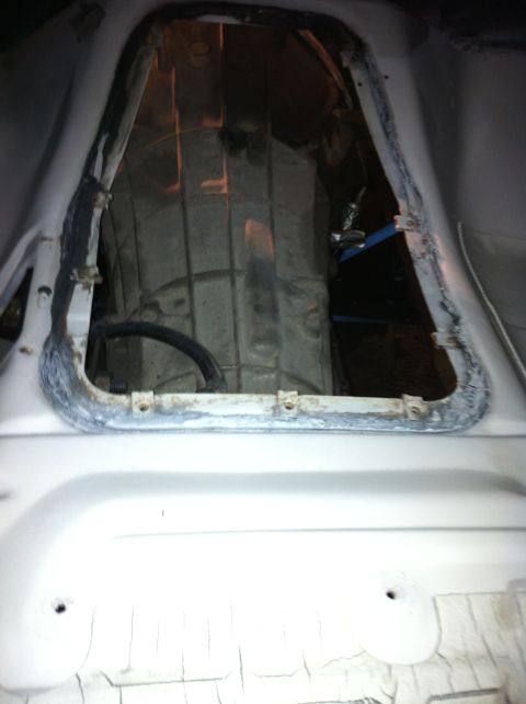 1992 Ford Bronco - Interior view of a vehicle's transmission tunnel, revealing the drivetrain.
