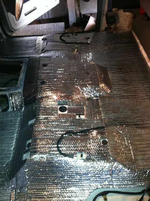1992 Ford Bronco - The interior floor of a vehicle is covered in reflective insulation material.