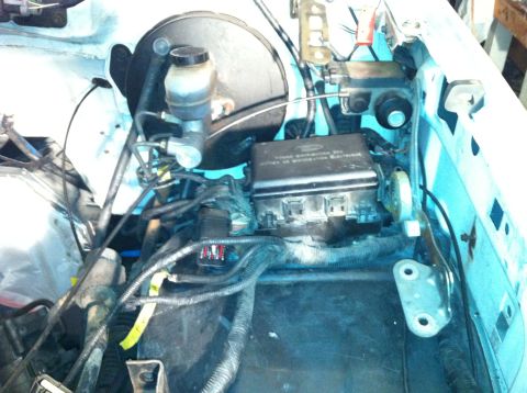 1992 Ford Bronco - Close-up of the engine bay with focus on the fuse box and brake fluid reservoir.