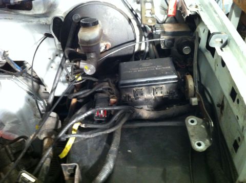 1992 Ford Bronco - Close-up view of the engine bay, focusing on the fuse box and brake master cylinder assembly.