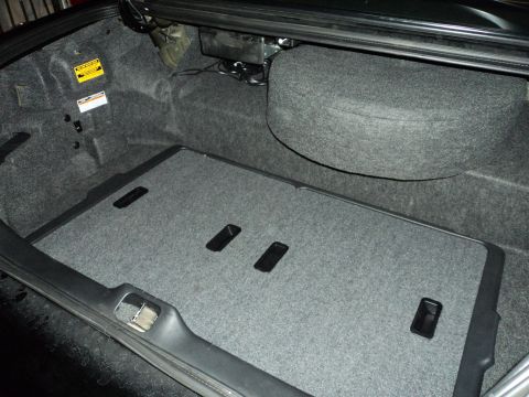2004 Mercury Grand Marquis - The carpeted trunk interior features a spare tire cover and a removable floor panel.
