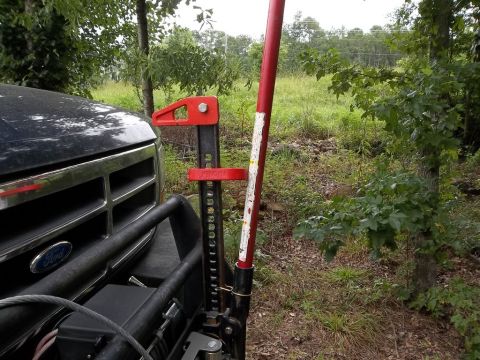 1995 Ford Bronco - A 1995 Ford Bronco is equipped with a Hi-Lift jack attached to its front bumper, ready for off-road use.