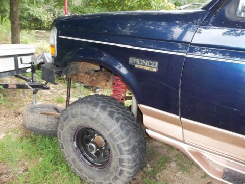 1995 Ford Bronco - 1995 Ford Bronco with custom suspension and tires, parked outdoors.