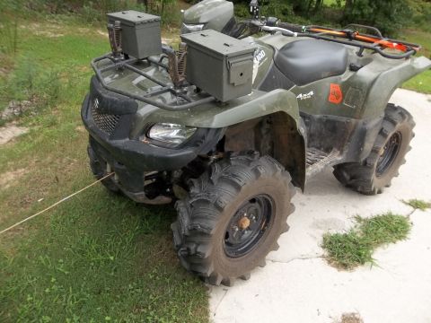 1995 Ford Bronco - ATV equipped with ammo cans on the front rack, parked outdoors.
