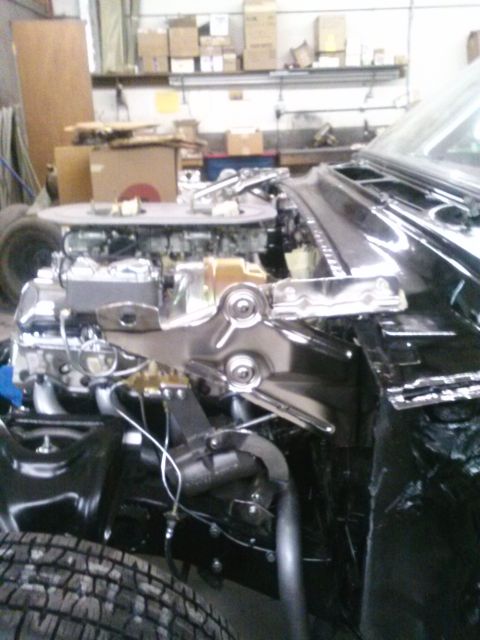 1960 Ford Falcon - Close-up view of a car's engine bay, showing the carburetor and engine components.