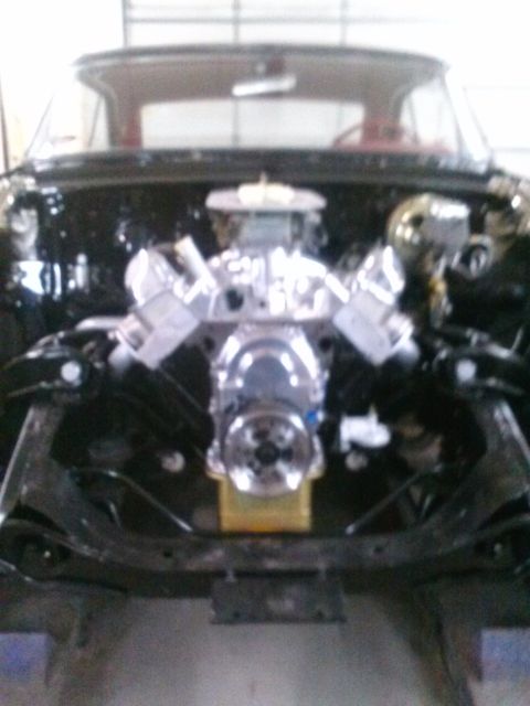1960 Ford Falcon - A chrome V8 engine is installed in the engine bay of a vehicle, with the interior visible through the windshield.