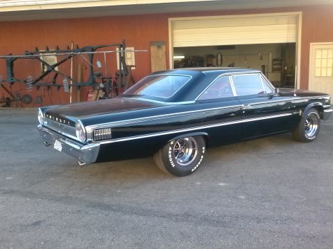 1960 Ford Falcon - This black coupe displays a distinctive grille and chrome accents, suggesting a 1963 model year.