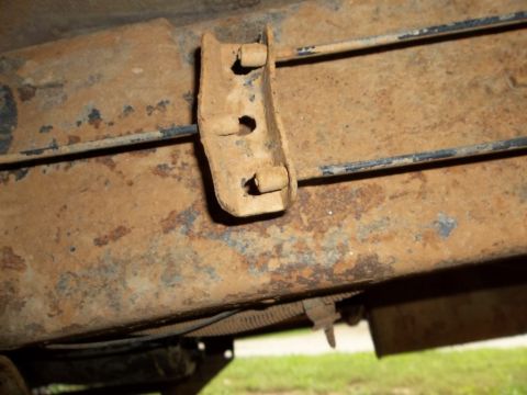 1995 Ford Bronco - Close-up of a rusted bracket and frame on a vehicle, showing signs of wear and age.