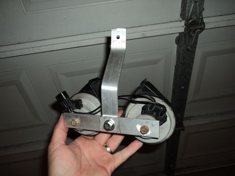 2004 Mercury Grand Marquis - A custom bracket holding two horns is presented, likely for a vehicle modification.