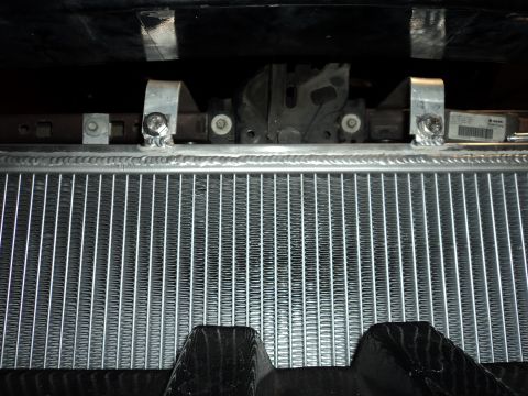 2004 Mercury Grand Marquis - Close-up of an aftermarket aluminum radiator, showing custom welded mounting brackets.