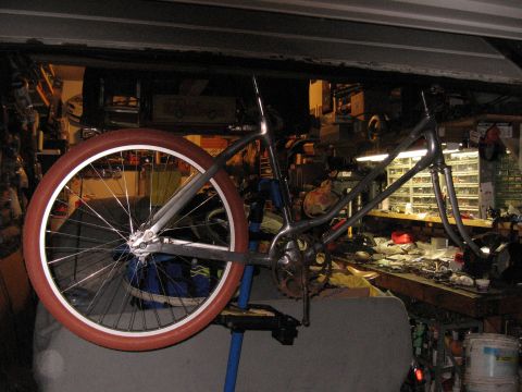 1994 Ford Bronco - A bicycle frame is mounted on a stand, with one wheel visible in a workshop setting.