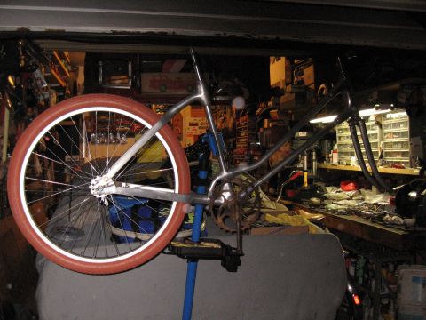 1994 Ford Bronco - A bicycle frame is mounted on a repair stand in a workshop environment.