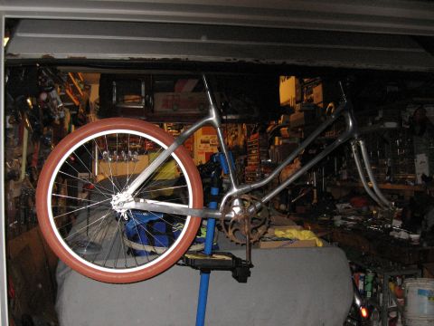 1994 Ford Bronco - A bicycle frame is mounted on a repair stand, surrounded by tools and supplies in a garage.
