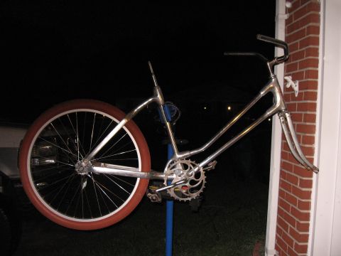 1994 Ford Bronco - The frame of a bicycle, possibly a cruiser, is shown with one wheel attached and leaning against a brick structure.