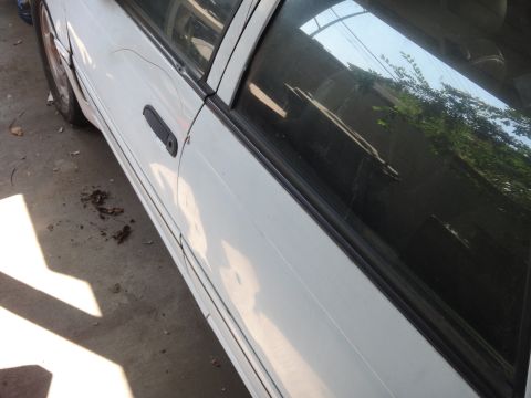 1990 Ford Taurus - Side view of a 1990 Ford Taurus showing the door and window panel.