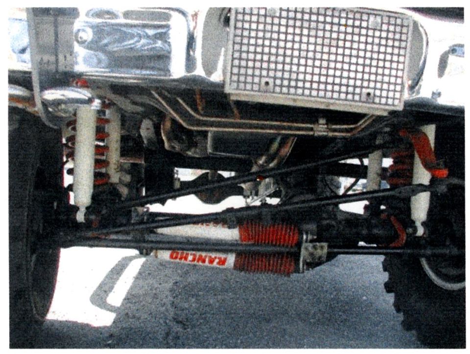 Undercarriage view of a vehicle showing Rancho shocks and suspension parts