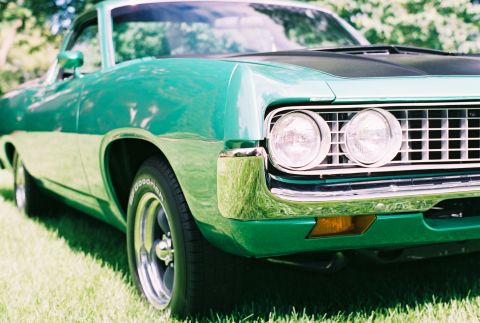 1971 Ford Ranchero - Front quarter view of a green Ford Ranchero parked on grass. Features a distinctive grille and headlights.