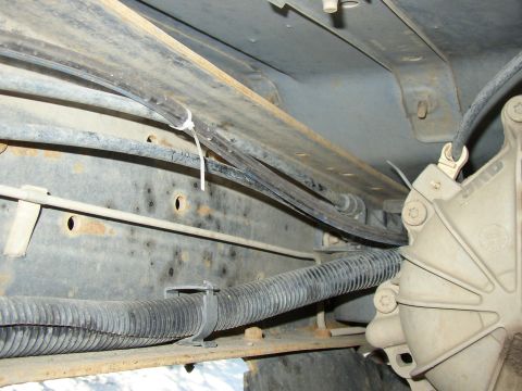 1989 Ford Bronco - where the line parallels the wire loom/fuel line on the left frame rail.