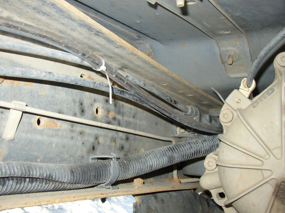 where the line parallels the wire loom/fuel line on the left frame rail.