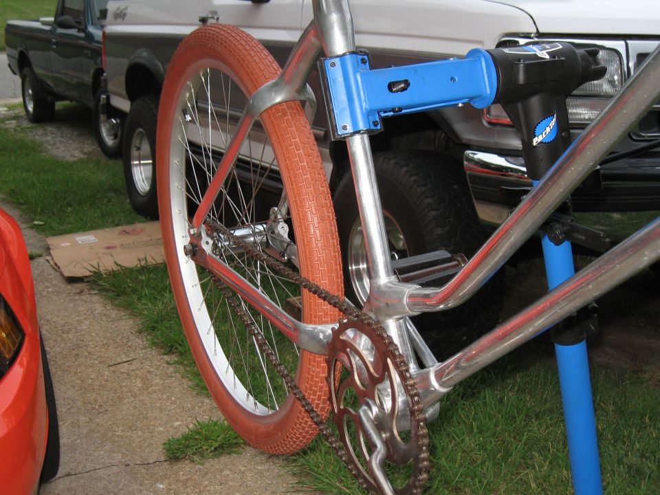 Bike on repair stand, with two trucks in background