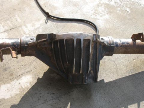 1989 Chevrolet C/K Pickup - A close-up view of a rusty rear axle differential assembly, likely removed from a vehicle.