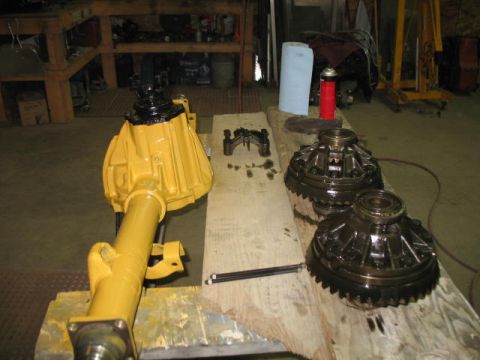 1989 Chevrolet C/K Pickup - Differential assembly and gears are laid out on a workbench, possibly for repair or inspection.