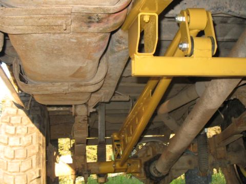 1989 Chevrolet C/K Pickup - This photo shows the undercarriage of a truck, focusing on the suspension and fuel tank.