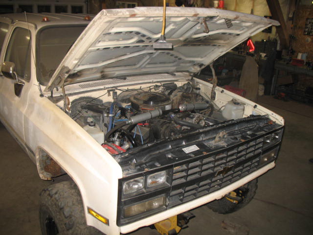 White 1988 Chevrolet C/K Pickup with hood open, showing engine and front grille
