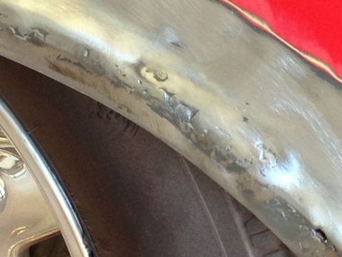 1964 Ford Fairlane - Detail of a car's fender and wheel well, showing areas of bodywork and a portion of the tire.