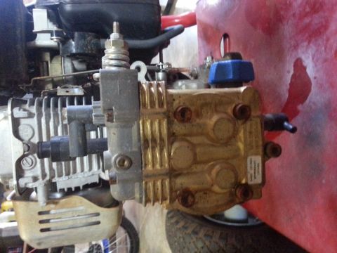 1995 Ford Bronco - Close-up of a pressure washer pump and engine assembly, showing mechanical components.