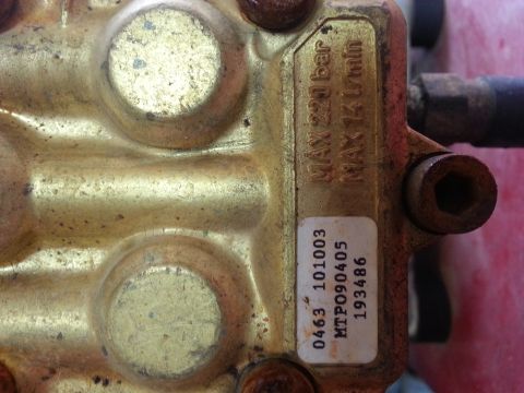 1995 Ford Bronco - Close-up of a brass pressure washer pump part showing maximum pressure and flow rate specifications.
