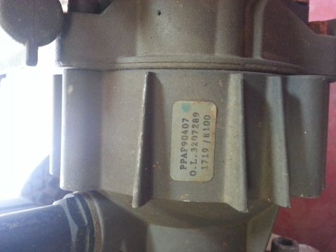 1995 Ford Bronco - Metal part with a label containing part numbers and a date code.