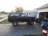 1994 Ford Bronco - This lifted 1994 Ford Bronco is parked in a driveway next to a garage.