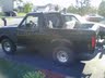 1994 Ford Bronco - A black Ford Bronco is parked outside, with another vehicle visible behind it.